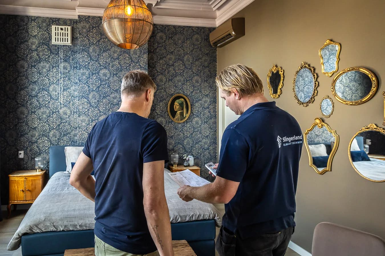 An engineer from Slingerland Klimaattechniek going through the installation with a customer